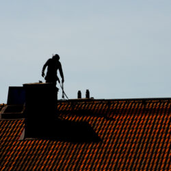 Silhouette,Of,A,Chimney,Sweeper,On,Top,Of,A,Roof.