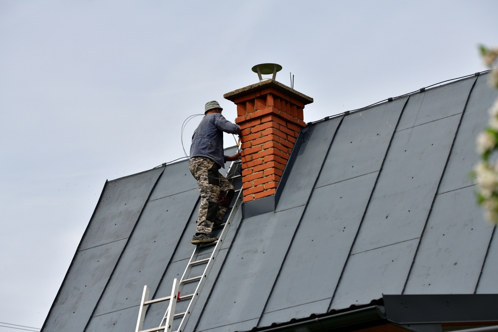 Traditional,Manual,Method,Of,Cleaning,The,Chimney,On,The,Roof