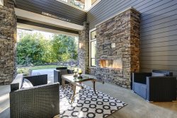Well,Designed,Covered,Patio,Boasts,Stone,Fireplace,,Wicker,Patio,Chairs