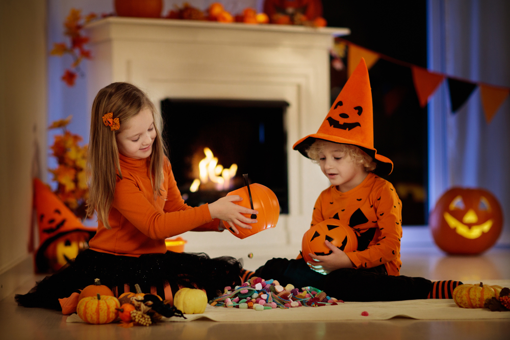 Little,Girl,And,Boy,In,Witch,Costume,On,Halloween,Trick