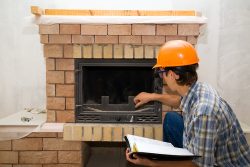 Building,Master,Examines,A,New,Fireplace