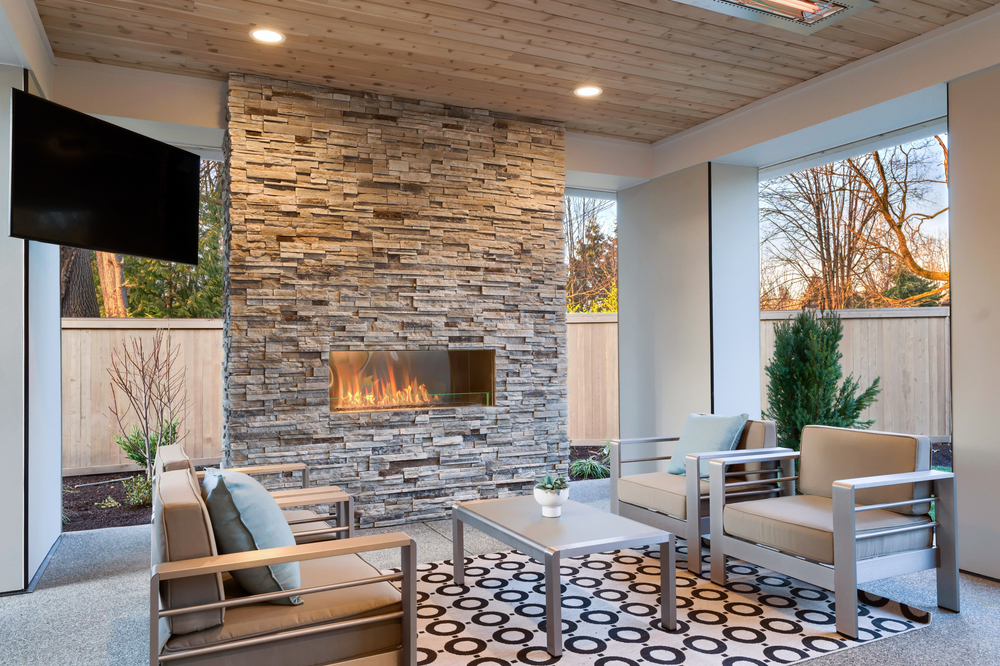 Luxury,Outdoor,Relaxing,Living,Room,With,Large,Stone,Fireplace,,Tv,